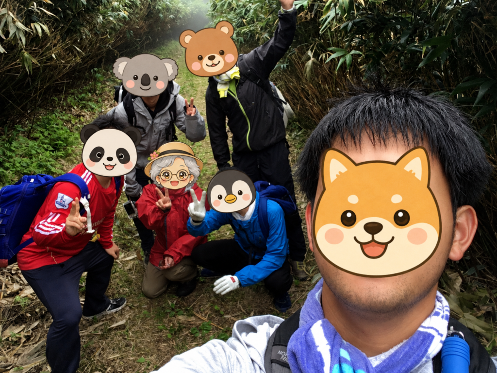 笹やぶの山道で記念撮影する6人のパーティー(著者を含む)